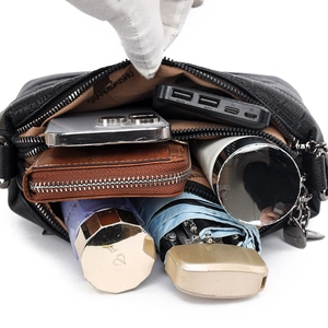 Black pebbled leather crossbody bag featuring three compartments and large capacity