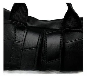 Close-up of precise black stitching and durable leather handle joint on the backpack