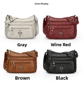Close-up of a multi-pocket soft leather shoulder bag in four colors with heart metal buckles