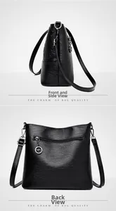 Vue macro du sac seau en cuir noir avec poche arrière zippée et pendentif métallique chic
