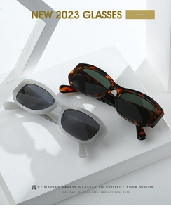Detail of square sunglasses with translucent grey and tortoiseshell frames on display