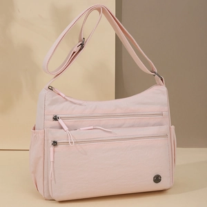 Pink nylon crossbody bag with multiple zip pockets and adjustable shoulder strap for women