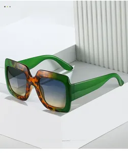 Detail of square two-tone sunglasses with green and tortoiseshell frame and gradient lenses