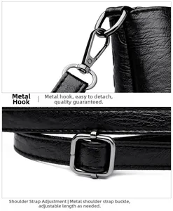Détail d'un sac seau en cuir noir avec crochets métalliques et bandoulière réglable