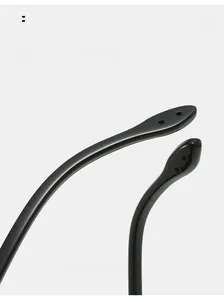 Macro shot of curved glossy black sunglass arms with unique circular decorative holes