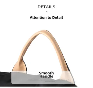 Macro detail of ergonomic round beige leather handle on a black nylon travel backpack