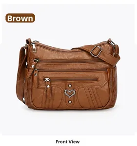 Detailed front view of brown multi-pocket faux leather shoulder bag with heart buckle