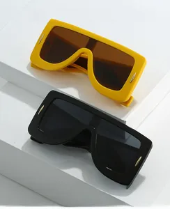 Detail of modern oversized square sunglasses with metallic rivet accents on the temples