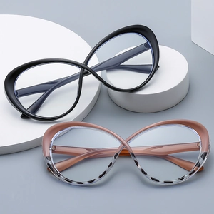 Chic cat eye blue light glasses in matte black and tortoiseshell frame on white pedestals