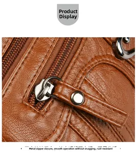 Detail of smooth hardware zipper closure on brown lychee texture leather shoulder bag
