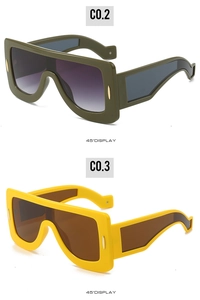 Detailed 45-degree view of futuristic oversized sunglasses in yellow and dark green