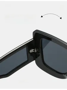Detail of durable metal hinge on futuristic oversized square sunglasses with black frame