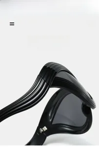 Detail of lightweight super elastic black wave sunglasses with futuristic cat-eye frame