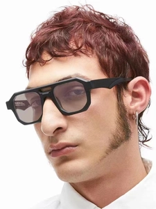 Detail of square geometric sunglasses with bold black frames and gradient purple lenses