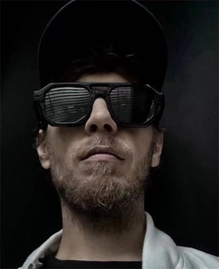 Macro view of men's black geometric square sunglasses with thick frames and dark lenses