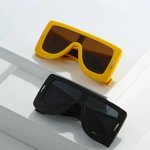 Futuristic oversized square sunglasses in yellow and black with silver rivet accents