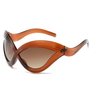 Futuristic cat-eye sunglasses with amber wave frame and gradient lenses on white background