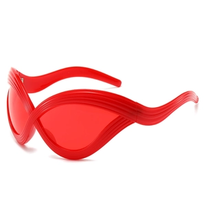 Futuristic red Y2K cat-eye sunglasses with wavy textured frames and red lenses