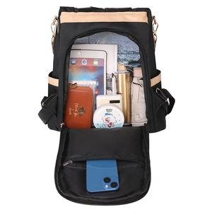 Large black nylon travel backpack showing spacious interior with tablet and daily essentials
