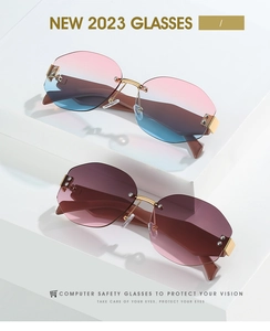 Close-up of rimless gradient sunglasses with geometric cut lenses and gold bridge