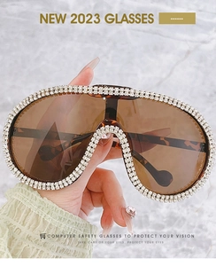 Detail of luxury pilot sunglasses with crystal embellishments and tortoise temples