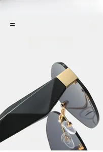 Detail of rimless sunglasses with gold square hinges and black geometric temples