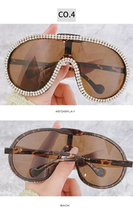 Detail of luxury pilot sunglasses featuring tortoiseshell frames and sparkling rhinestones