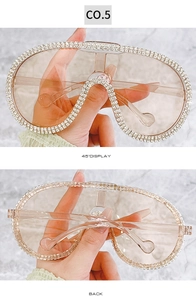 Detail view of oversized aviator sunglasses with crystal rhinestones and tinted lenses