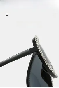Macro detail of luxury aviator sunglasses showing high-quality rhinestone-studded frames