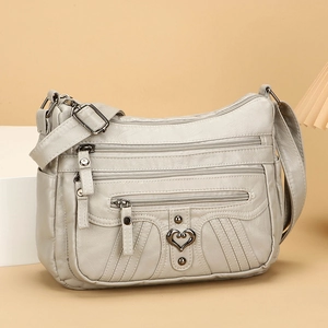 Beige soft leather crossbody bag for women with multi-pocket design and adjustable strap