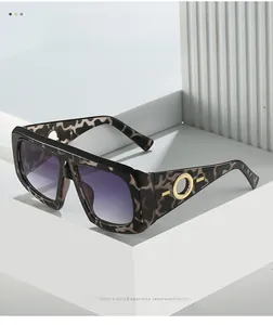 Close-up of leopard frame sunglasses with golden round metal hardware and purple lenses
