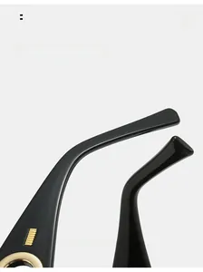 Detail of curved black sunglasses arms with decorative gold metal accents and 03 S/S logo