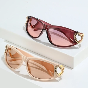Y2K heart sunglasses with gold hollow heart detail on white geometric stands