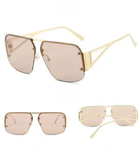 Detail view of champagne gold aviator sunglasses with studded gradient lenses and hollow frames