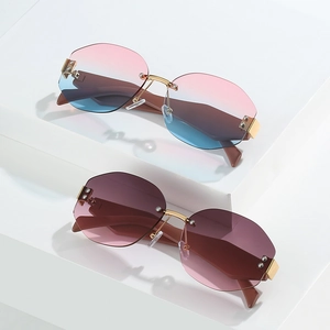Frameless polygonal sunglasses with gradient lenses on a modern geometric display