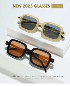 Detail of vintage square sunglasses with thick frames in cream and black on geometric stand