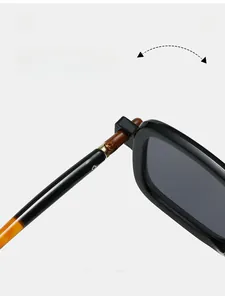 Detail shot of durable reinforced metal hinge on square black vintage sunglasses