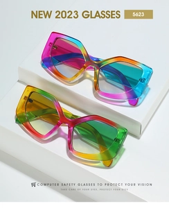 Detail view of colorful rainbow gradient cat-eye sunglasses on geometric white display