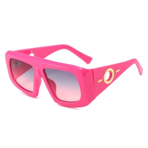 Pink oversized gradient sunglasses with gold circular accents and UV400 lenses