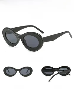 Three angles of retro oval cat eye sunglasses featuring thick black frames and dark lenses