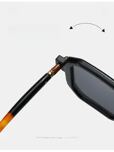 Close-up of durable metal hinge on stylish square sunglasses with amber textured arms
