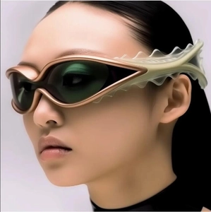Futuristic champagne gold cat-eye sunglasses with unique wavy textured temples for women