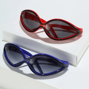 Futuristic cat-eye sunglasses with dual-tone frames on a geometric white display stand