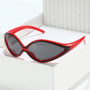 Futuristic red and black cat-eye sports sunglasses on a white geometric platform