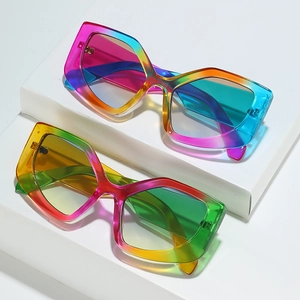 Cat eye sunglasses with vibrant rainbow gradient frames displayed on white pedestals