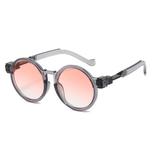 Retro round oversized sunglasses with gray translucent frames and orange gradient lenses