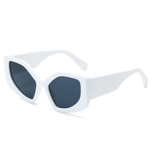White geometric cat eye sunglasses with dark lenses from a side front angle on white background