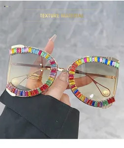 Close-up of golden frame sunglasses with rainbow rhinestones and pearl temple tips