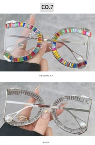Detail view of oversized silver metal frames with colorful crystals and pearl accents