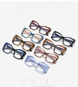 Flat lay of diverse TR90 cat eye glasses frames in various colors like tortoiseshell and blue